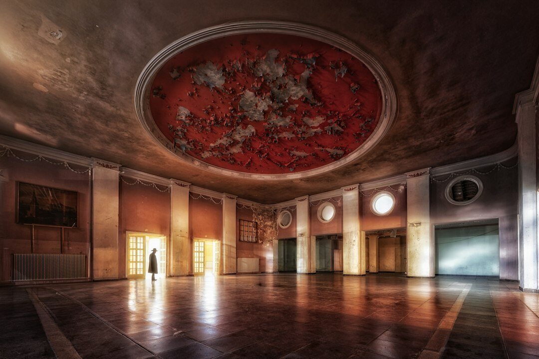 Ornate old theater interior with red seats and balconies