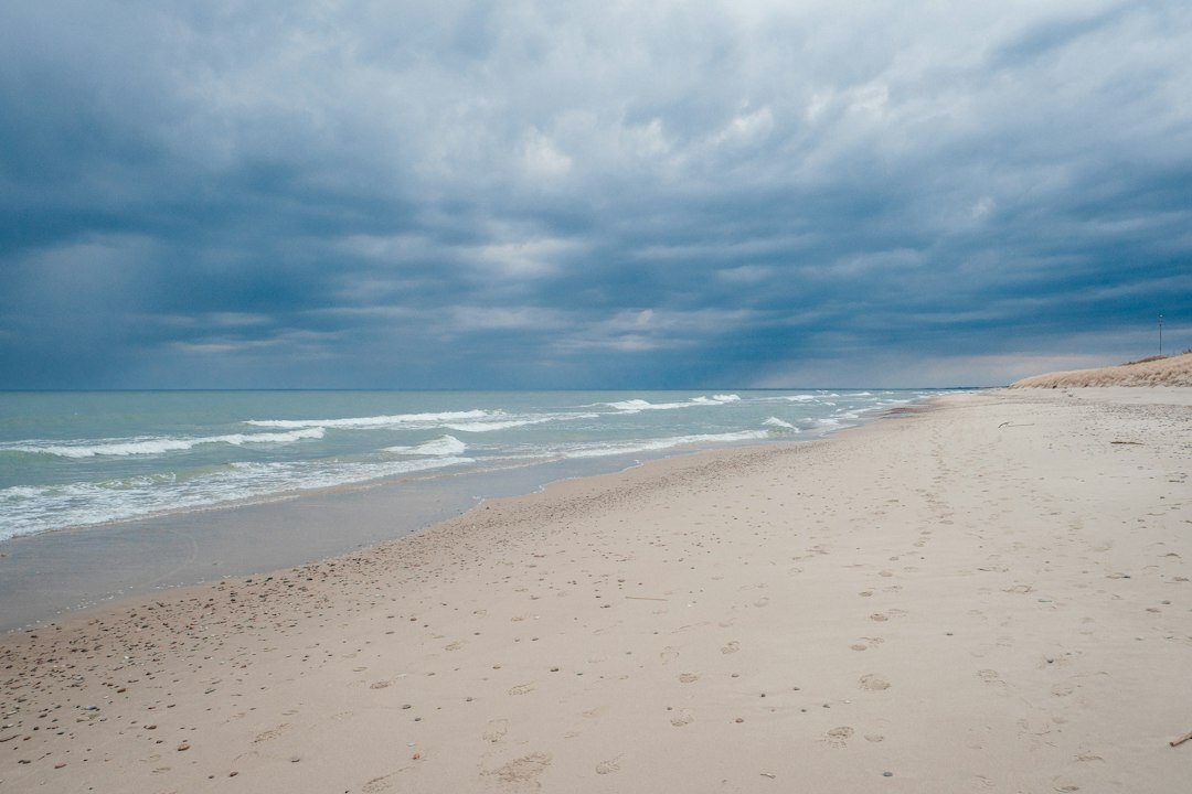 Empty sandy beach with dramatic clouds in Punta del Este