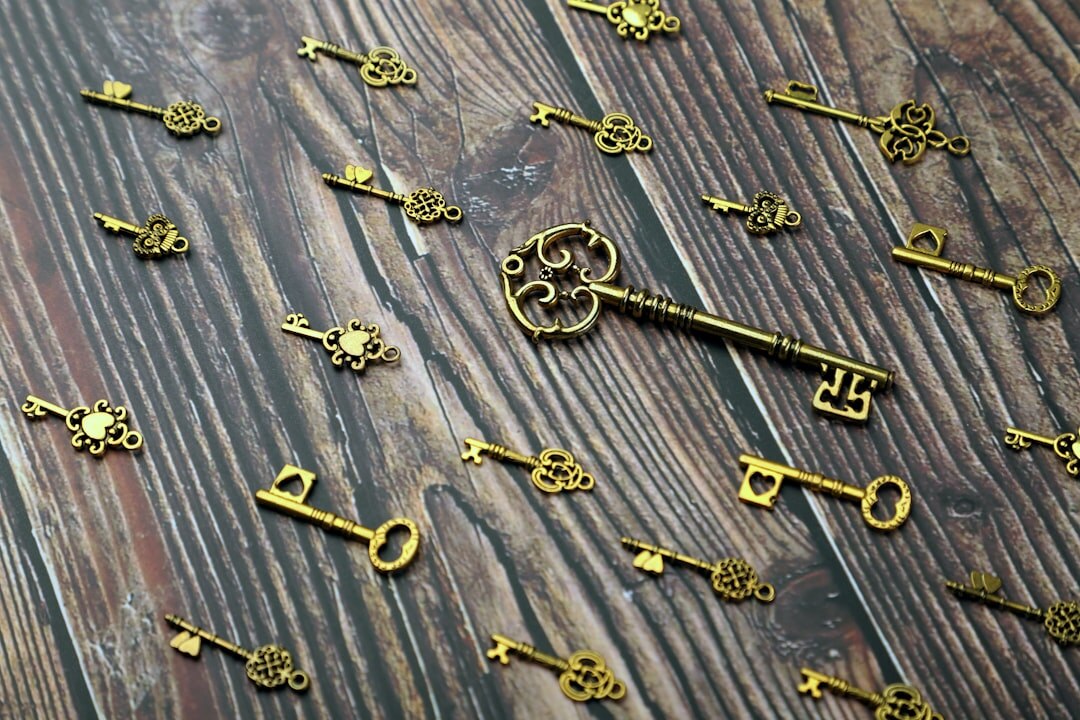 Old brass keys resting on an antique wooden surface