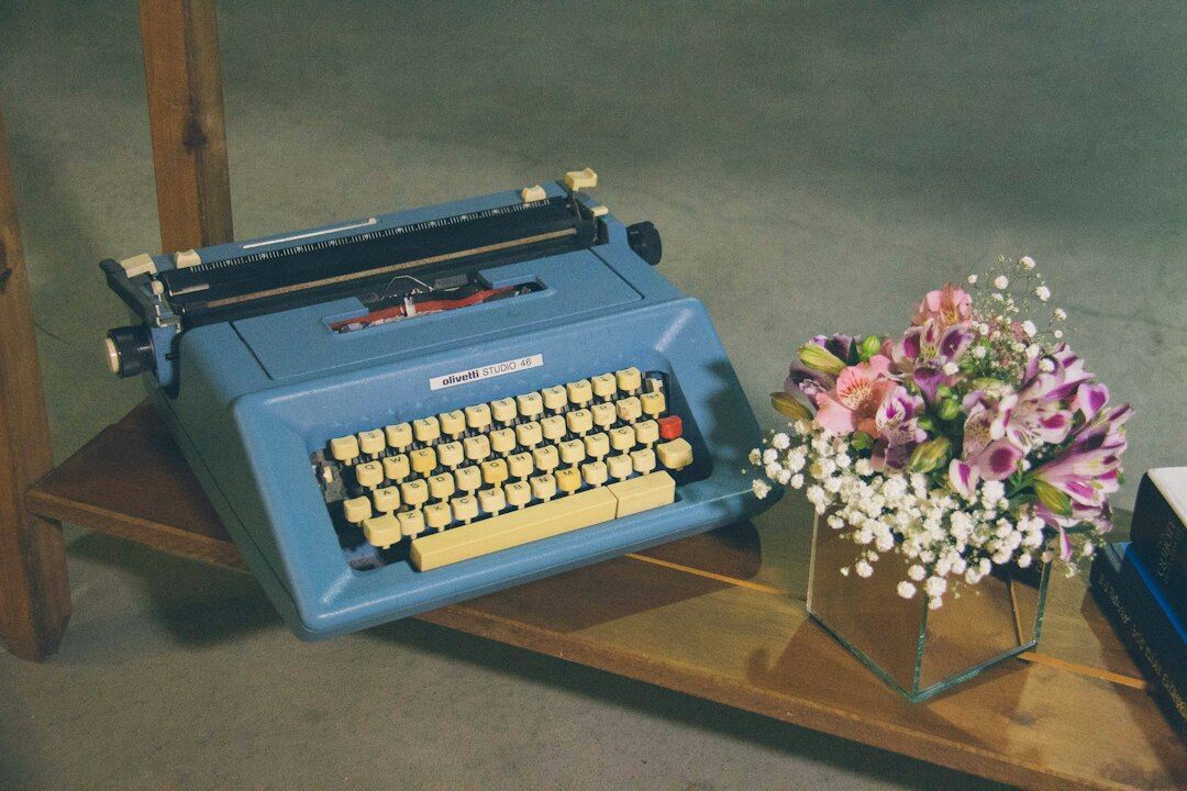 Vintage typewriter with a blank page on a wooden table