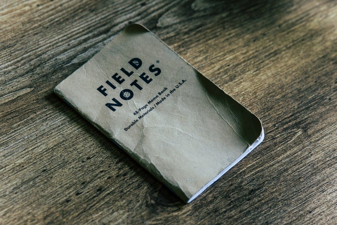 Detective notebook with handwritten notes and a pen